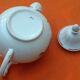 Old porcelain teapot with floral decoration