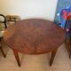 Oval extendable dining table in wood and walnut burl veneer.