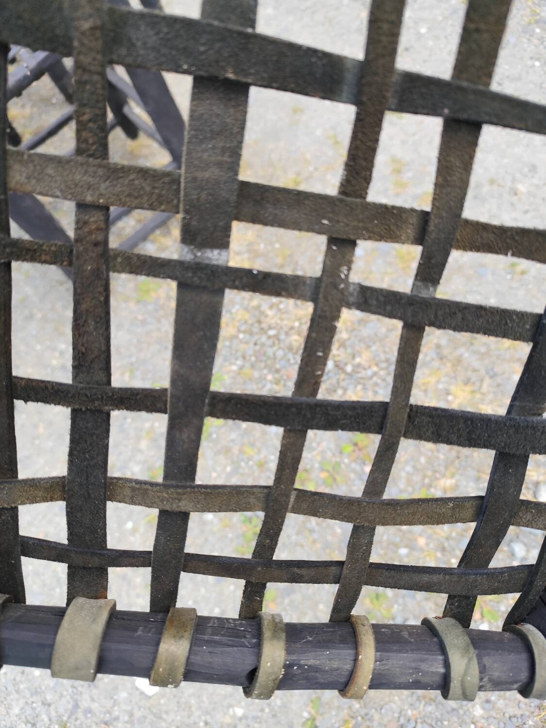 5 blackened wooden stools with woven leather seats by Nina Kaufmann