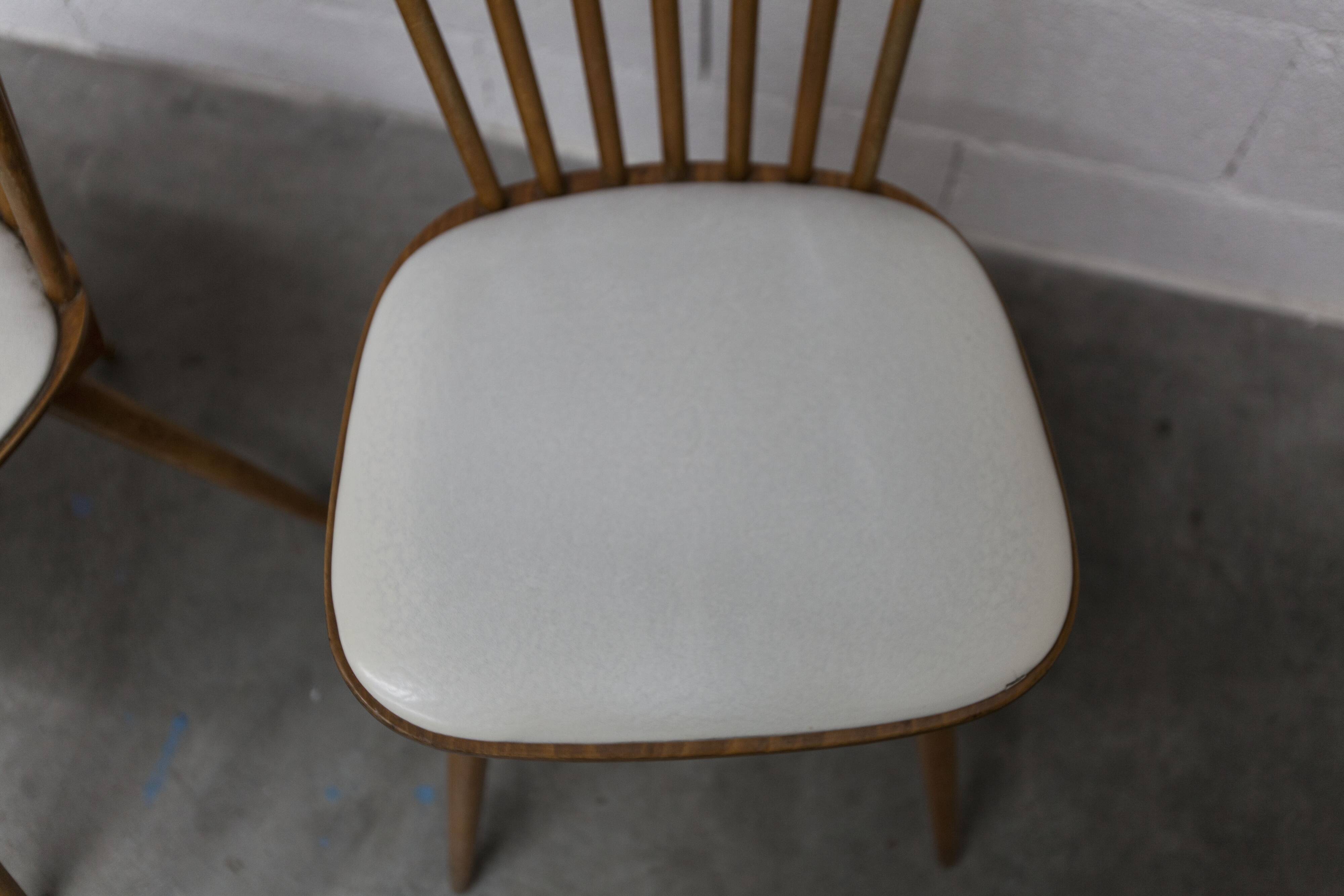 Pair of Baumann Menuet chairs, Honey patina, White vinyl seats