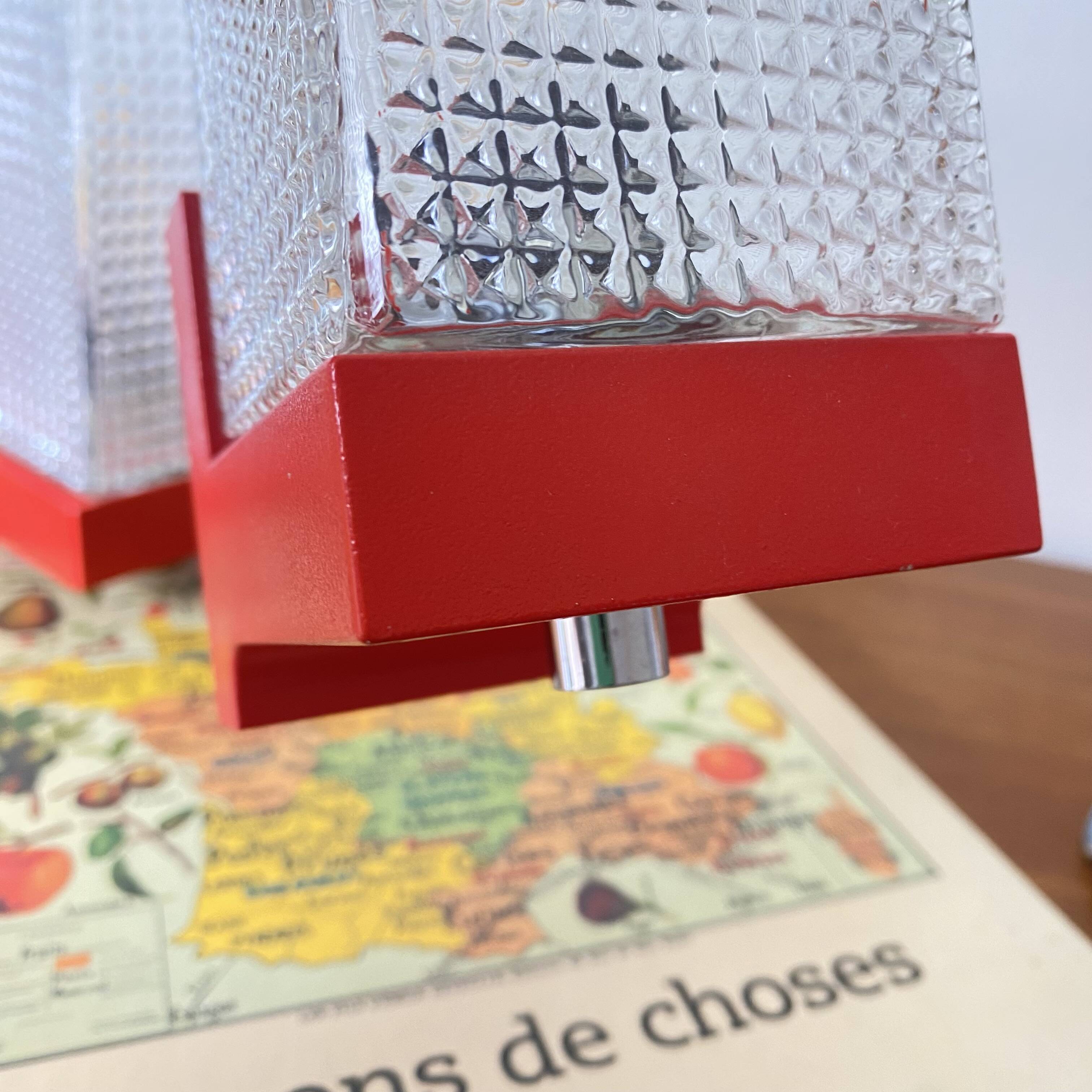 Pair of vintage wall lights in red plastic and clear glass.