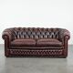 Classic cowhide Chesterfield sofa in English style with red/brown colours