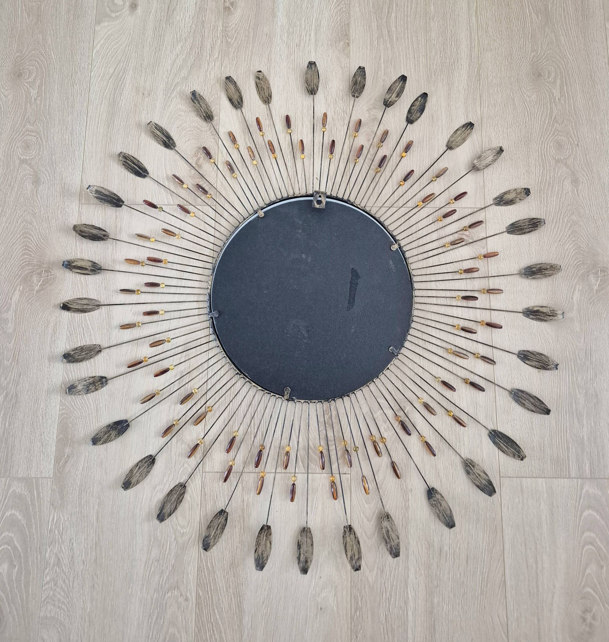 Vintage metal sun mirror in the style of Line Vautrin