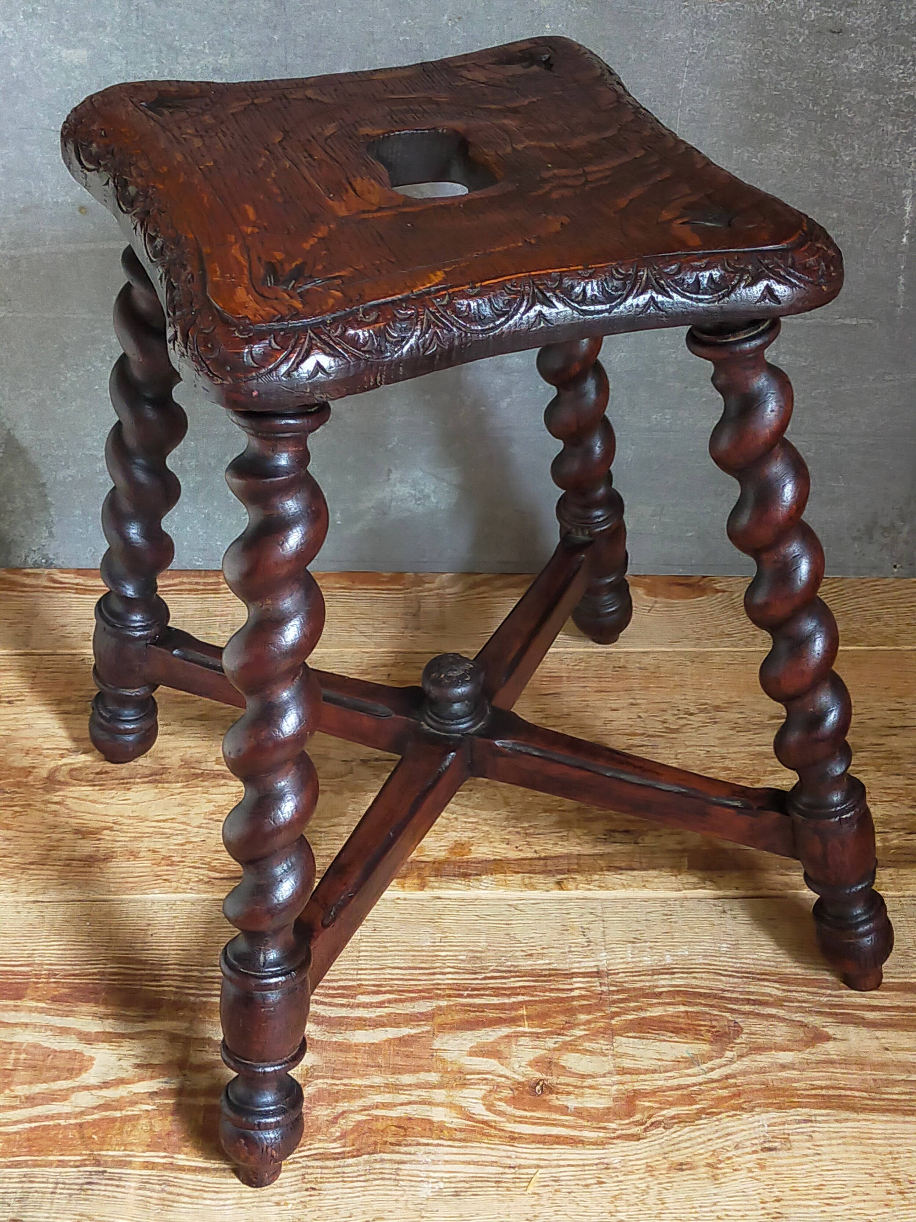 Antique stool in turned and carved solid wood