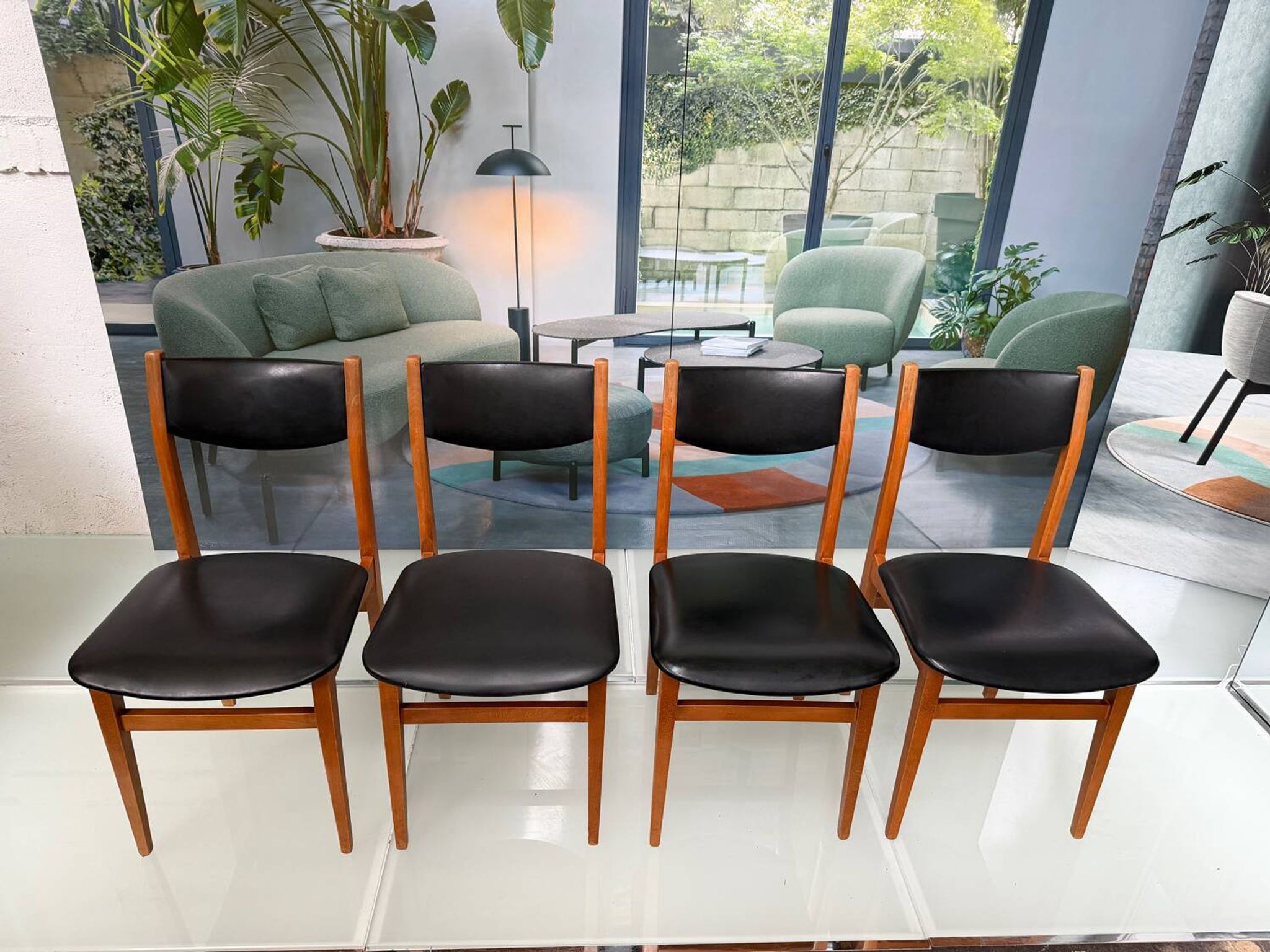 4 Scandinavian chairs in teak and black faux leather.