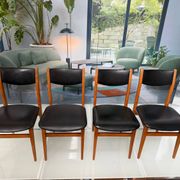 4 Scandinavian chairs in teak and black faux leather.