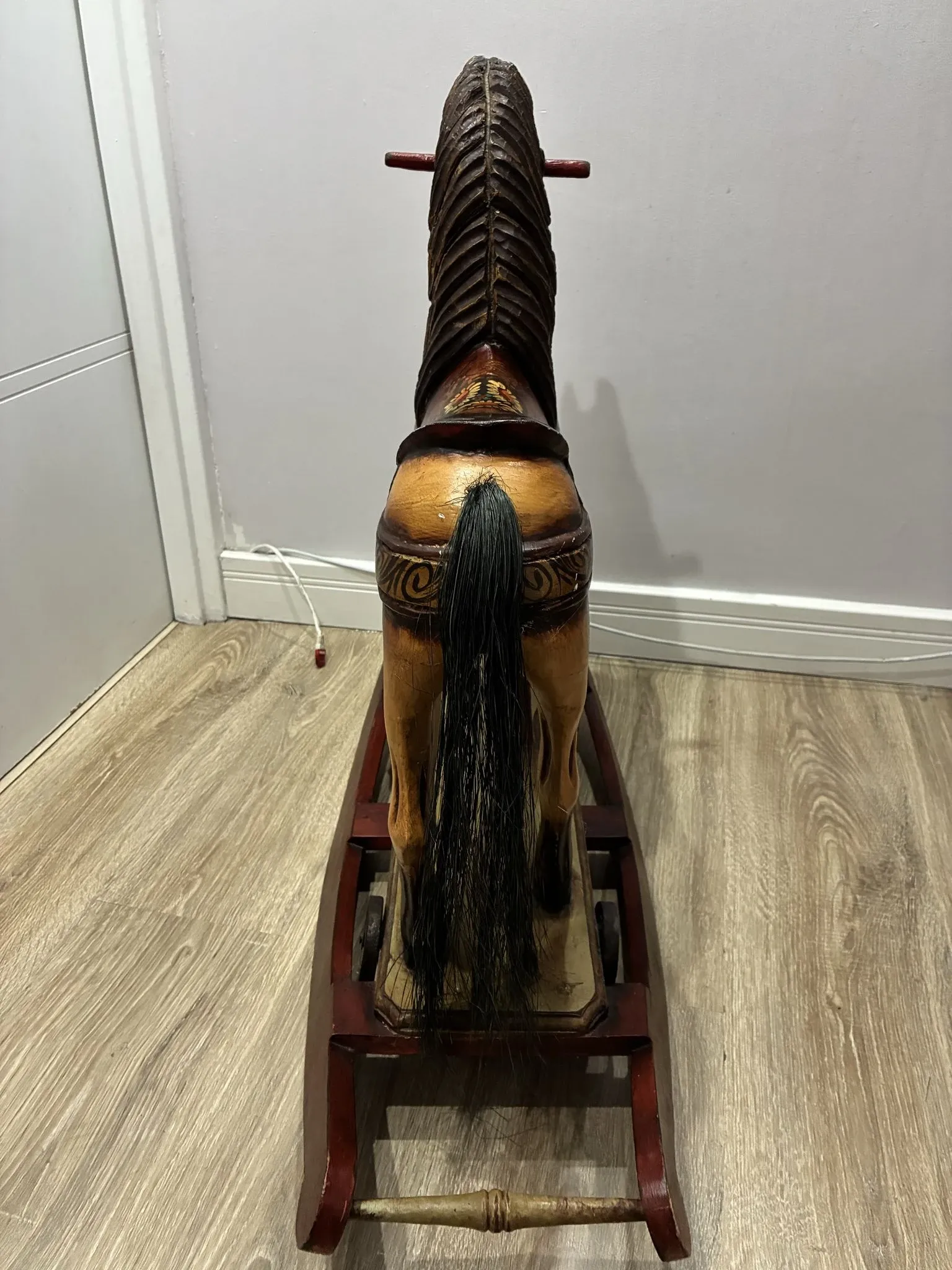 Antique hand-carved rocking horse on wheels, early 20th century