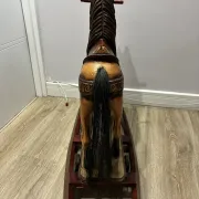 Antique hand-carved rocking horse on wheels, early 20th century