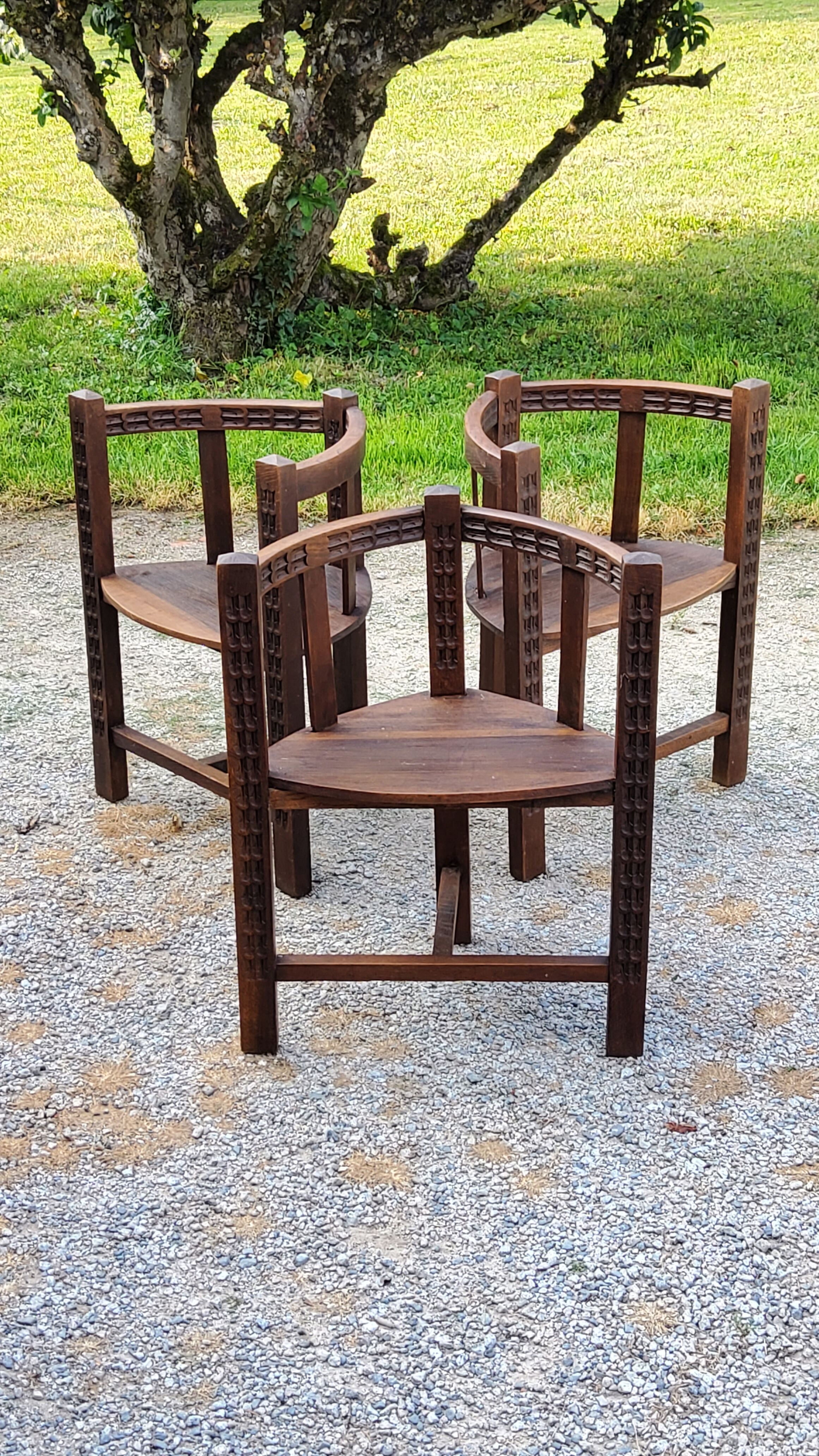 Set of three brutalist tripod armchairs in carved solid oak