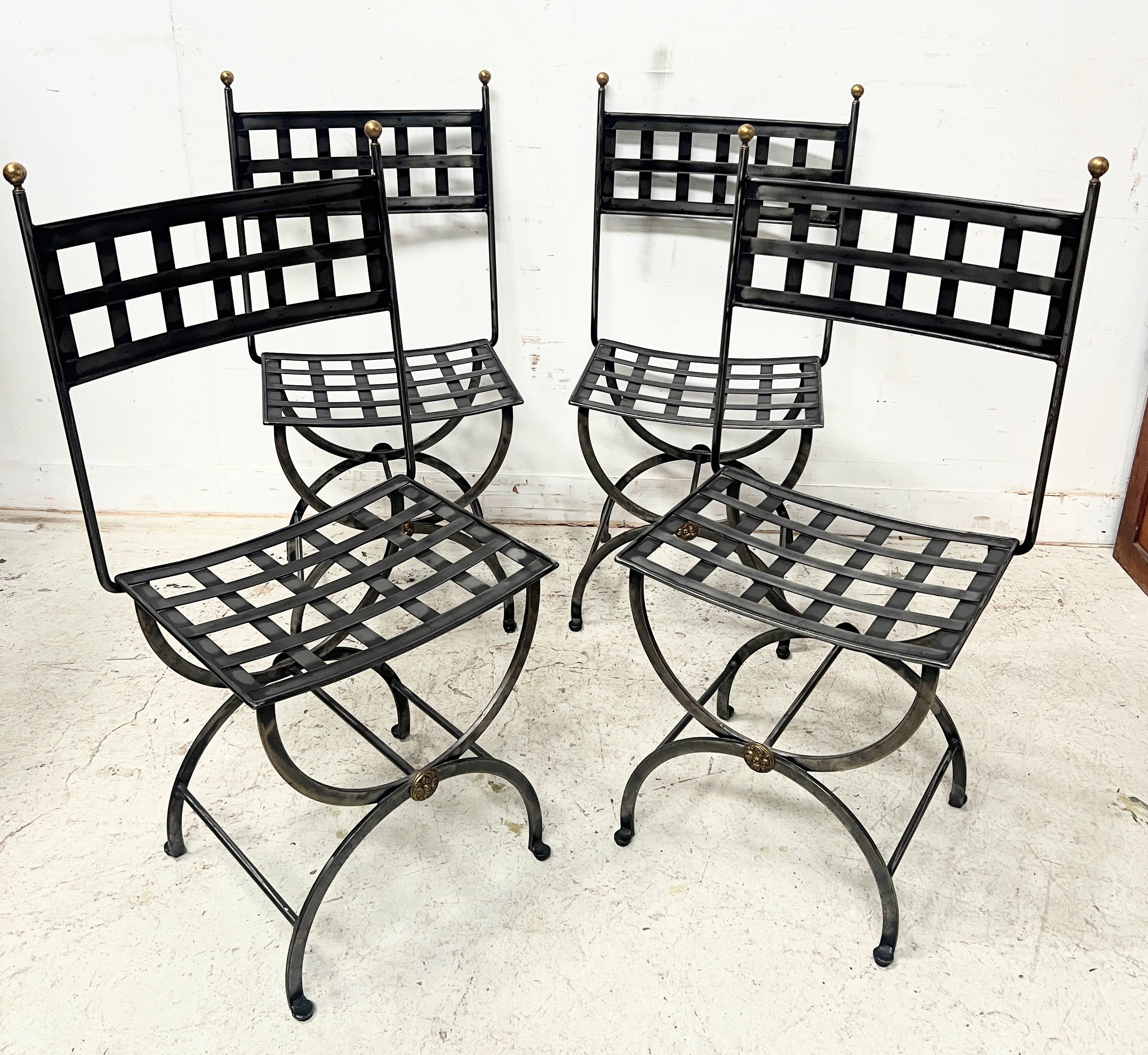 Set of four wrought iron chairs, with a reclining X-shaped base, seat and backrest.