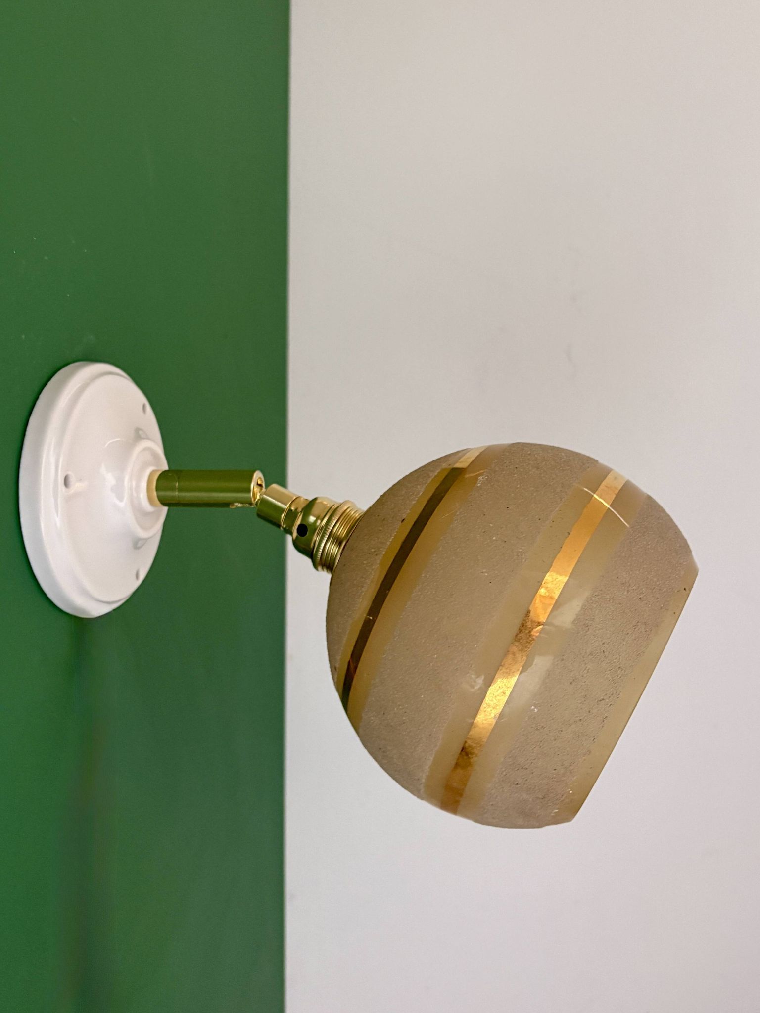 Vintage globe wall light in frosted yellow and gold glass.