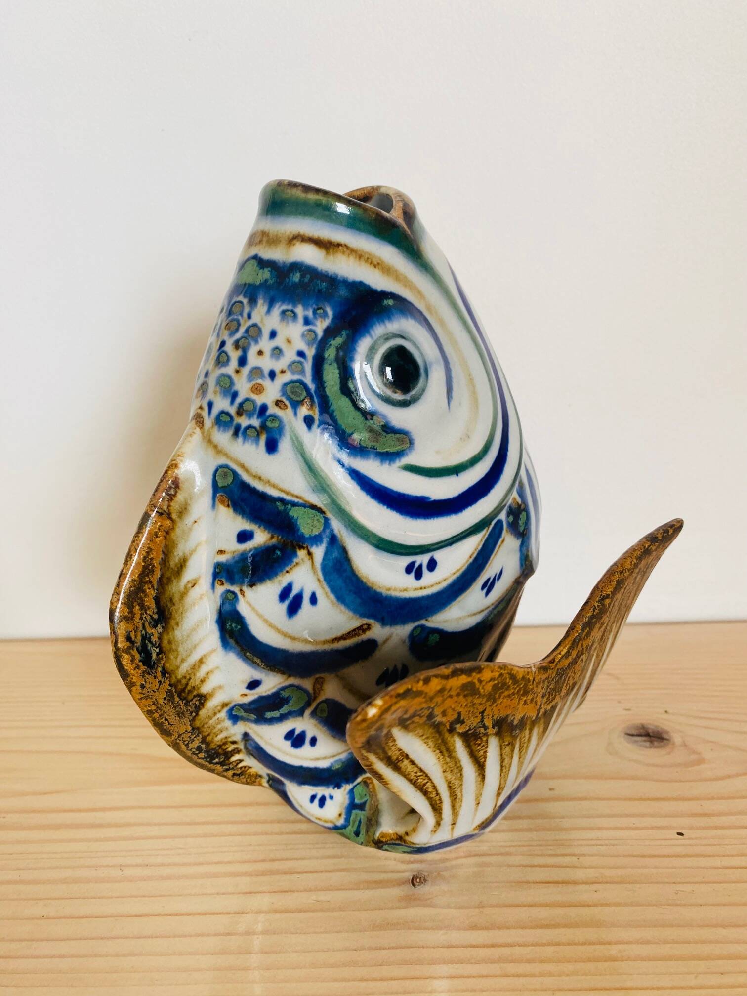 Blue ceramic zoomorphic vase in the shape of a poison.