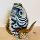 Blue ceramic zoomorphic vase in the shape of a poison.