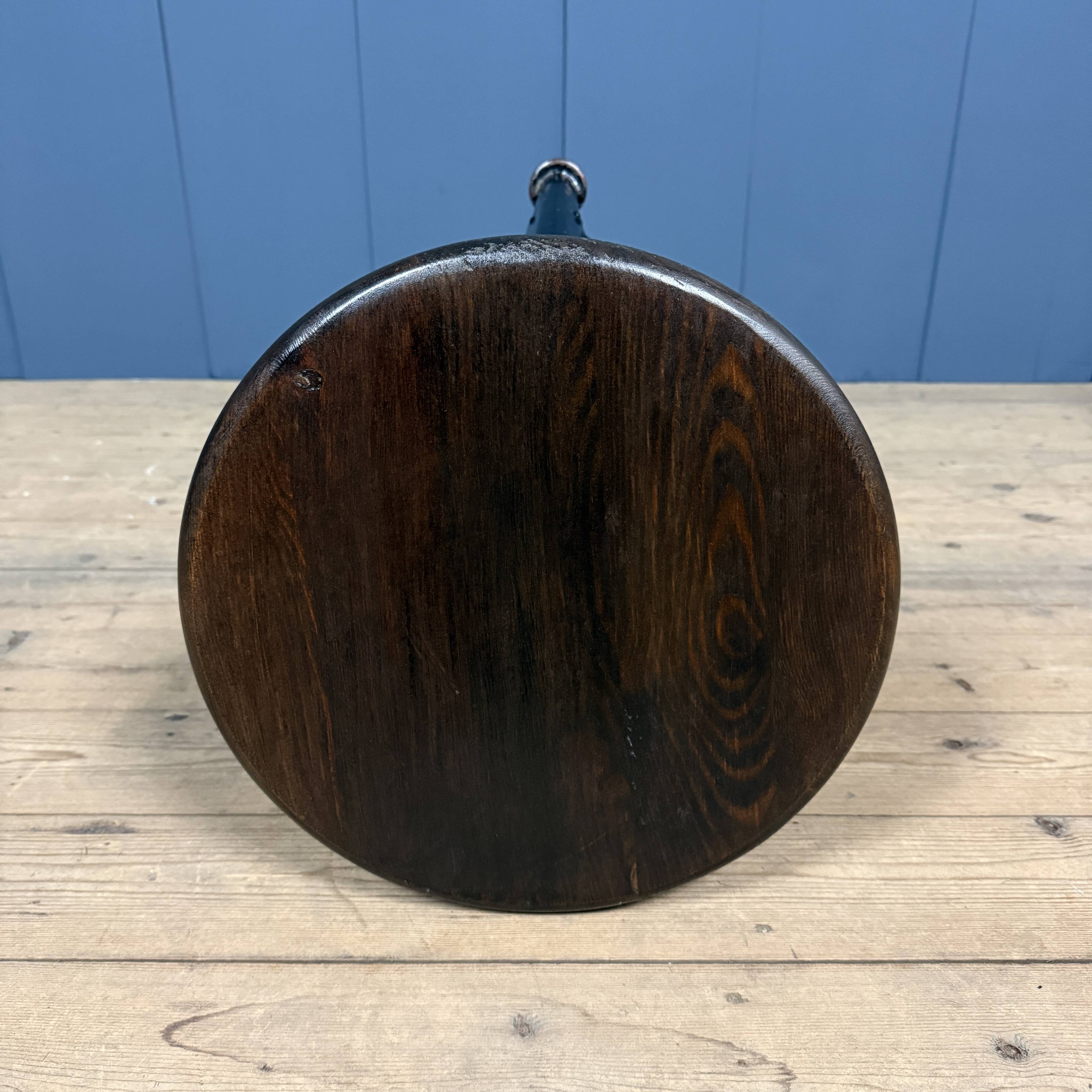 Unmarked black Rowac stool with a dark wood seat.