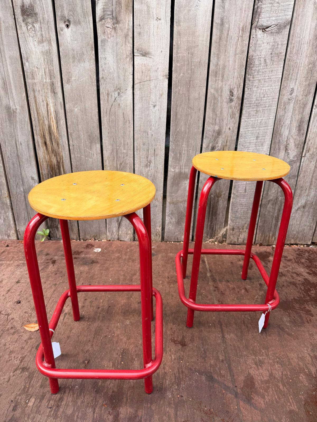 Vintage red industrial stool with a wooden seat, 1960s.