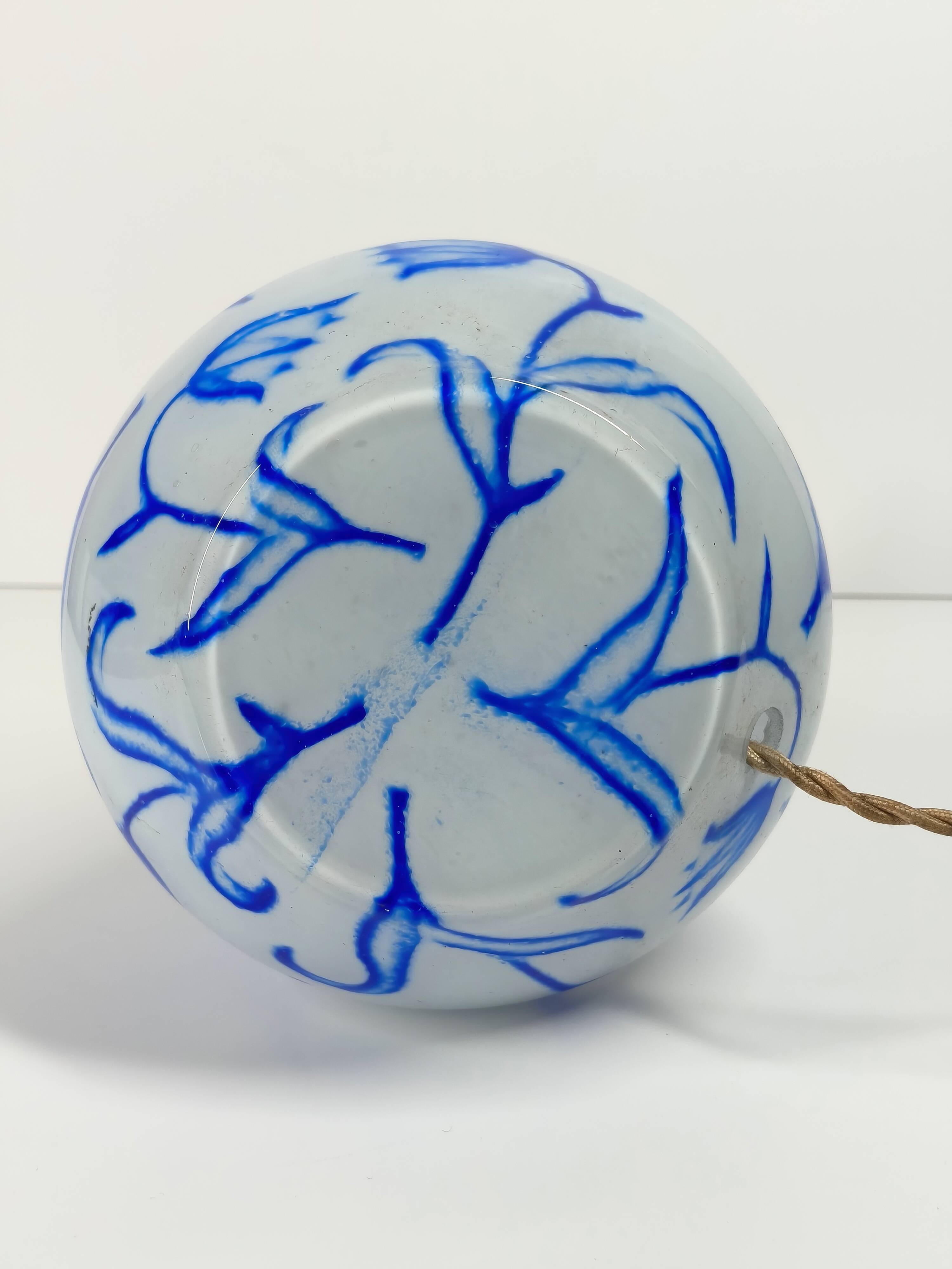 Antique table lamp in opaline glass with blue floral decoration.