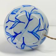 Antique table lamp in opaline glass with blue floral decoration.