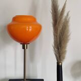 Table lamp with an old globe in vintage orange opaline