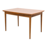 Dining table, 1960s, in walnut, slightly elliptical shape.