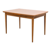 Dining table, 1960s, in walnut, slightly elliptical shape.