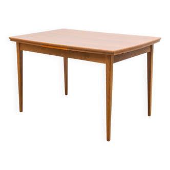 Dining table, 1960s, in walnut, slightly elliptical shape.