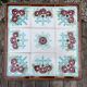 Antique wooden plant stand with ceramic tiles.