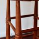 Antique wooden bar stool with a straw seat