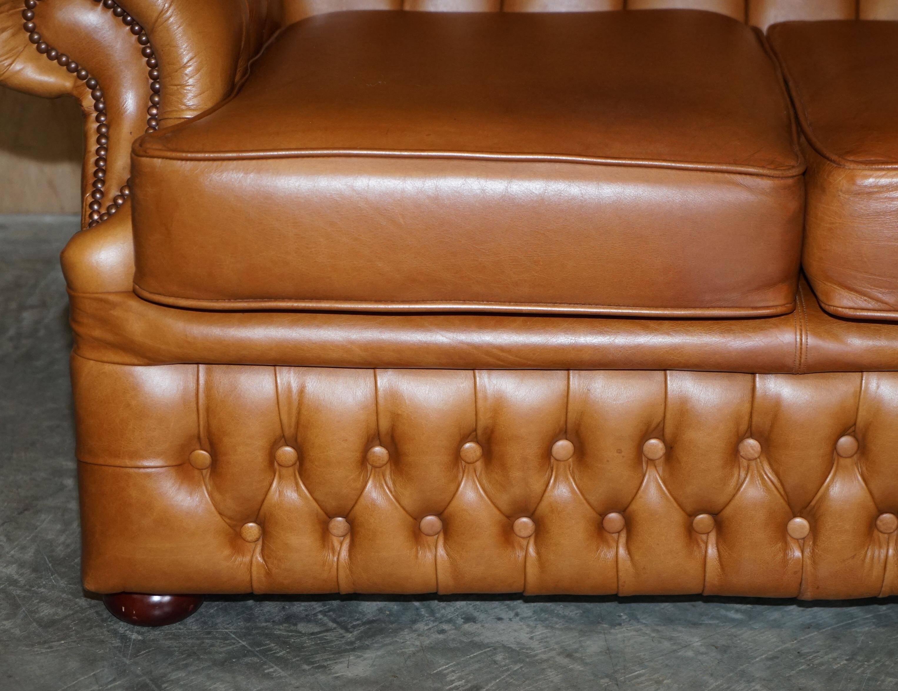 Small Chesterfield leather sofa with a high back.