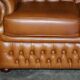 Small Chesterfield leather sofa with a high back.