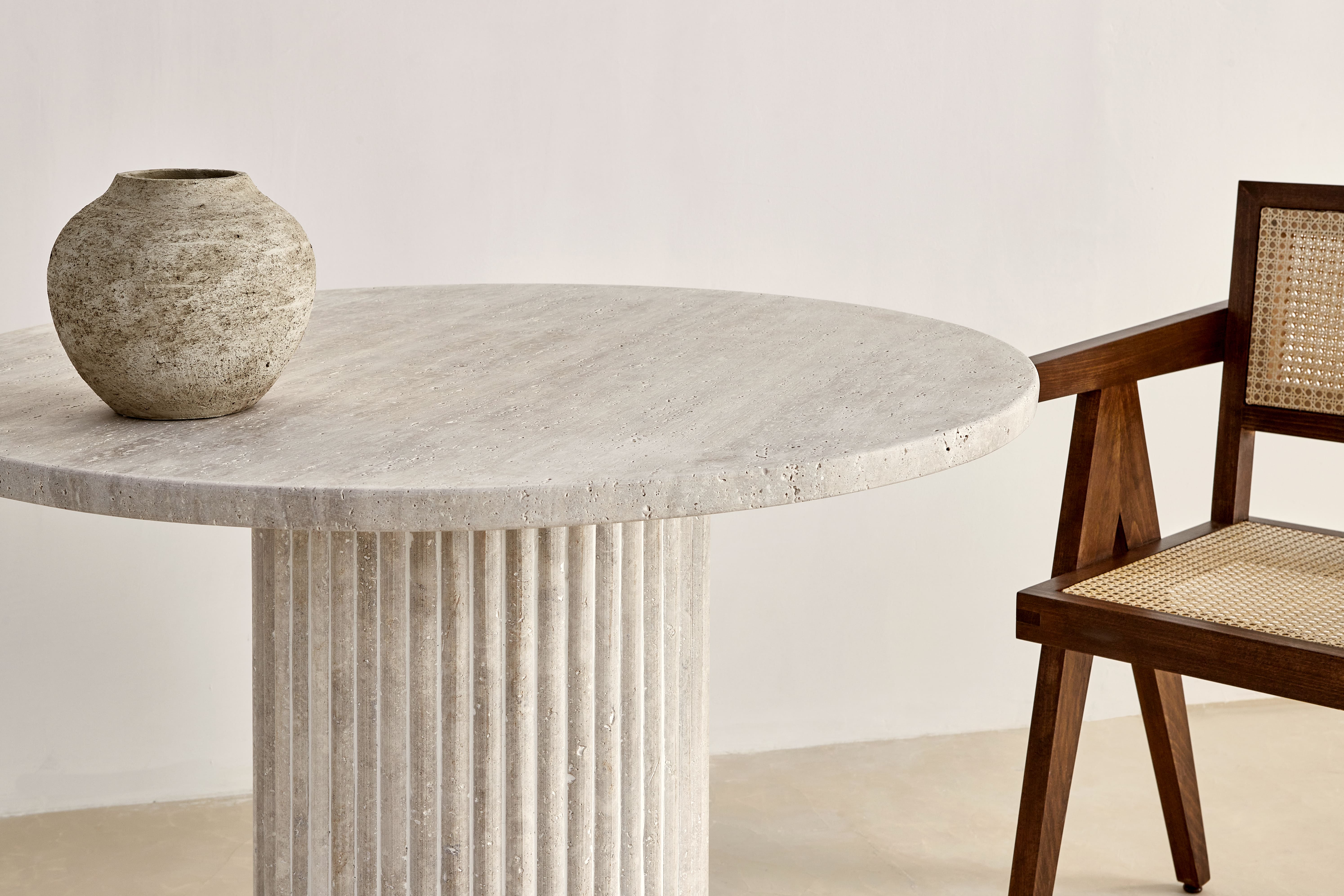 Omega circular dining table in natural travertine