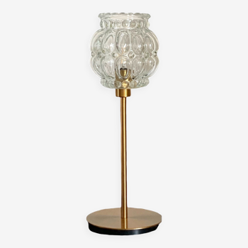 Table lamp with an antique glass globe lampshade and a gold base