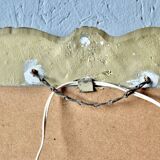 Old religious light frame in gilded stucco and curved glass