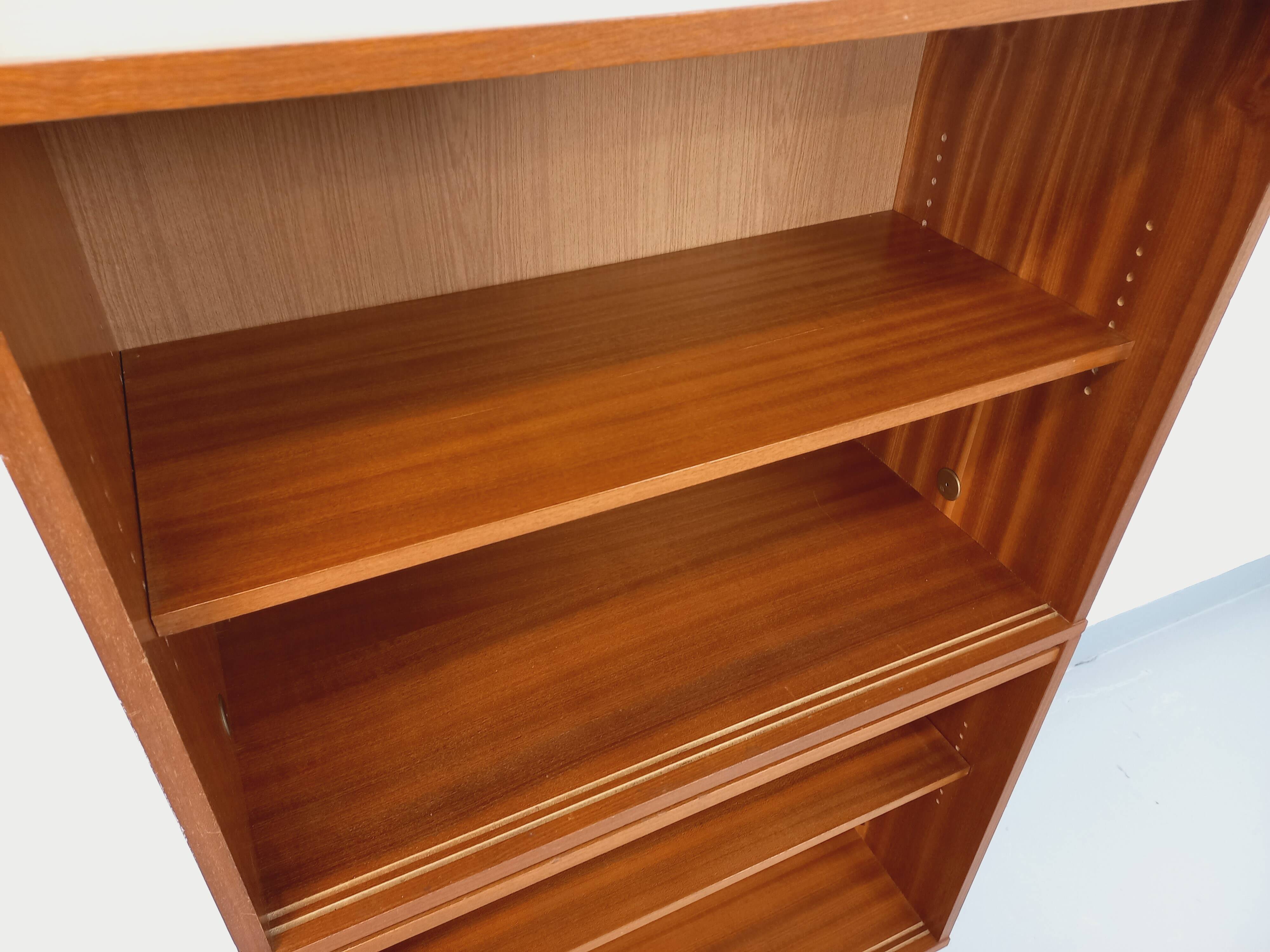 Vintage wooden bookshelf in teak style from the 1960s.