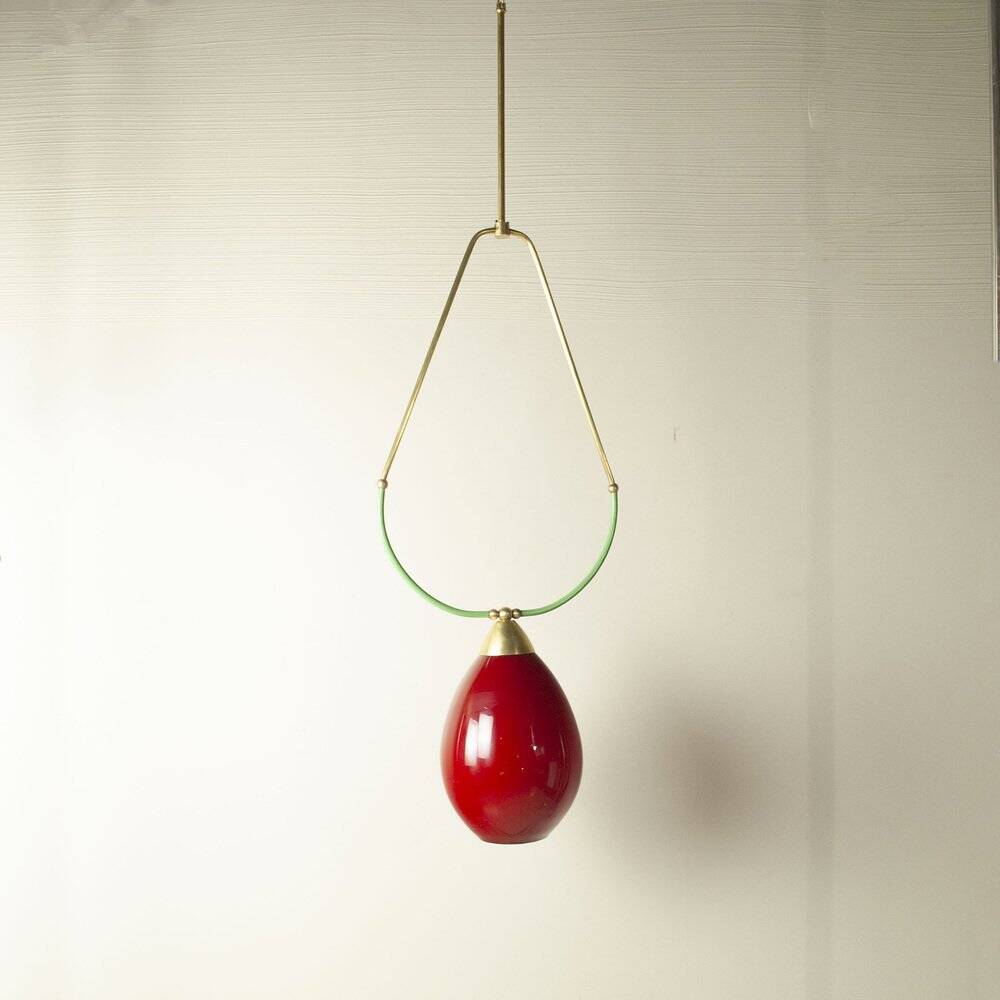 Hanging lamp with a brass frame in the shape of scales and a red-purple Murano glass diffuser.