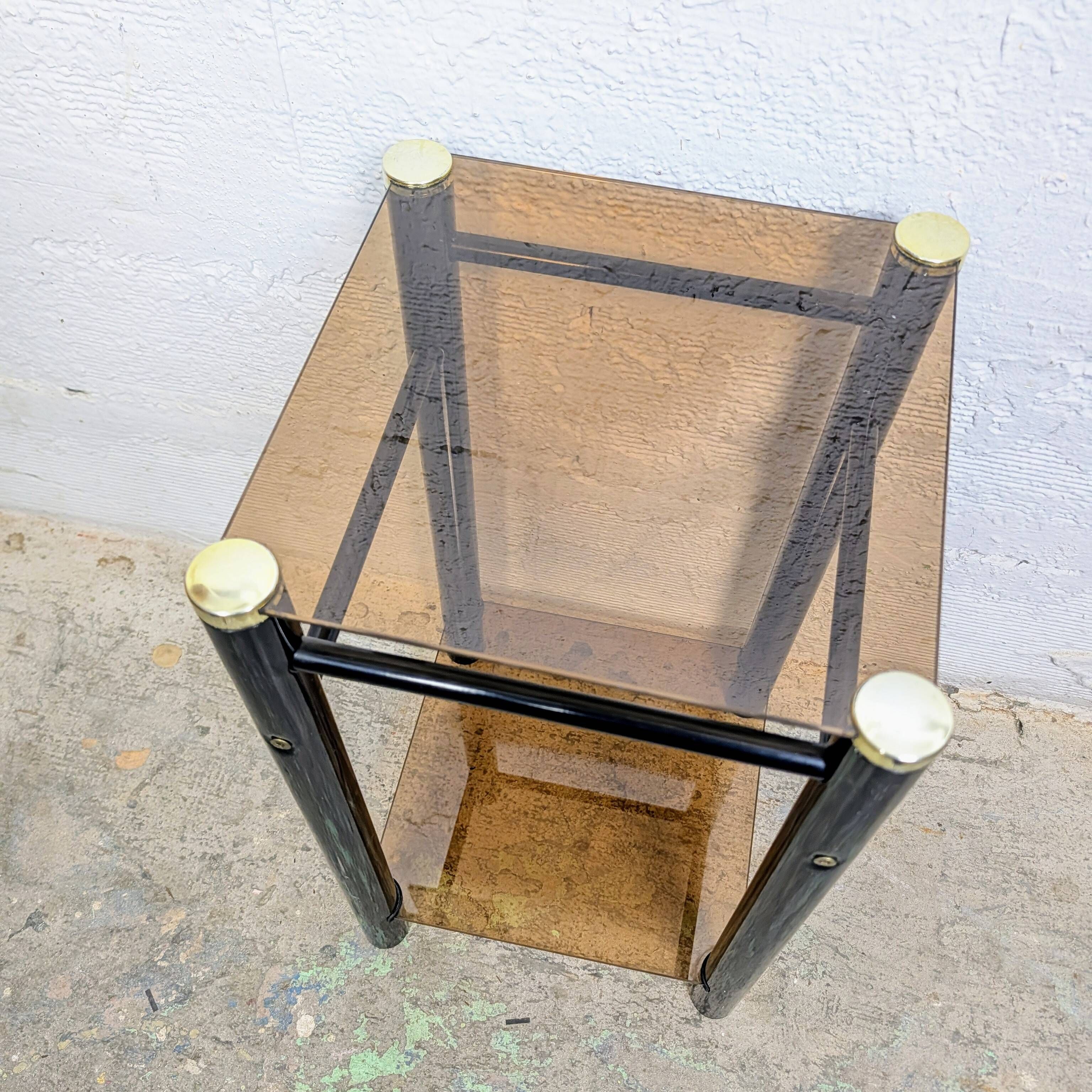 Vintage side table with two smoked glass tops and black metal.