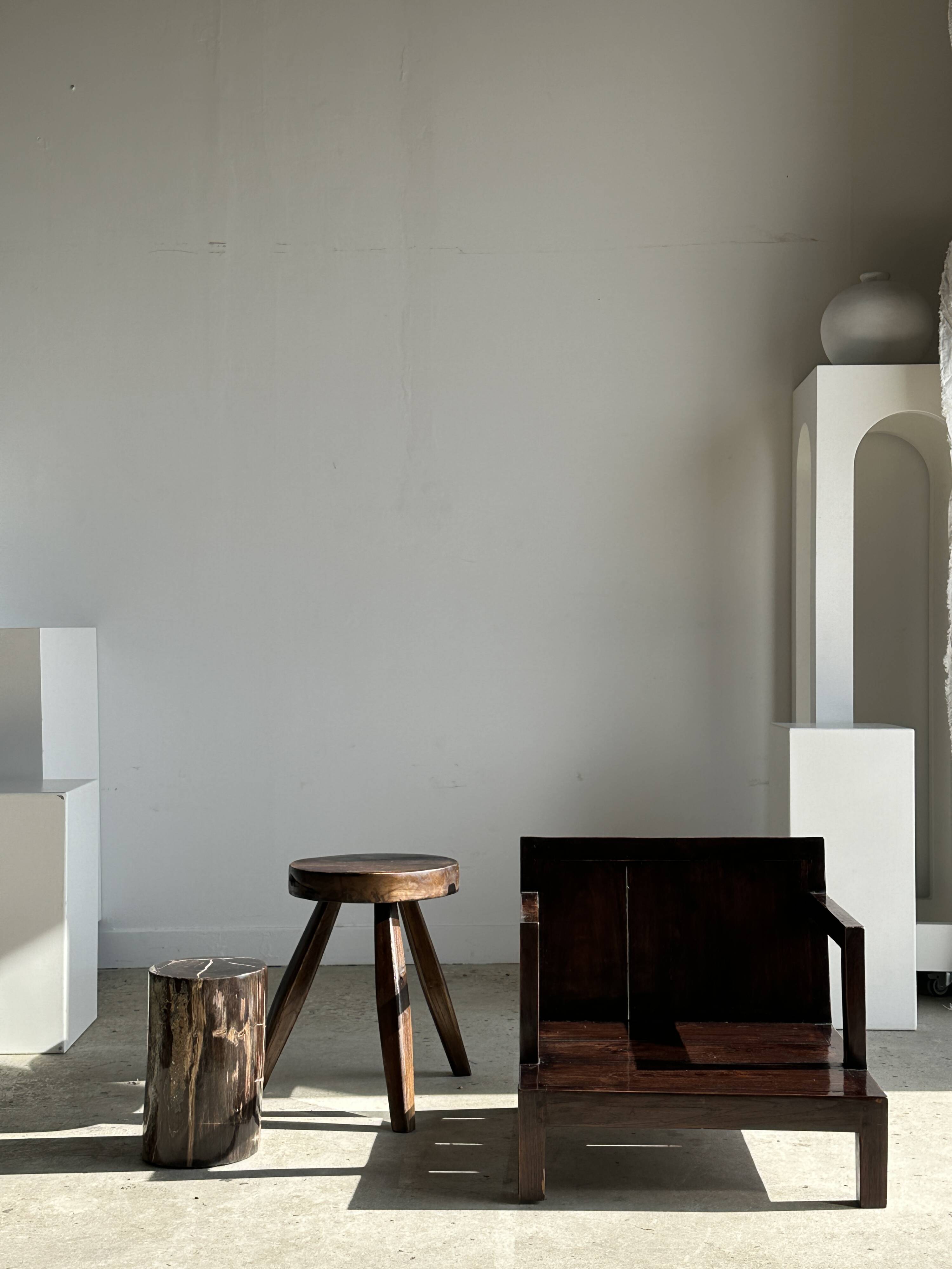 Small low armchair in varnished brown wood