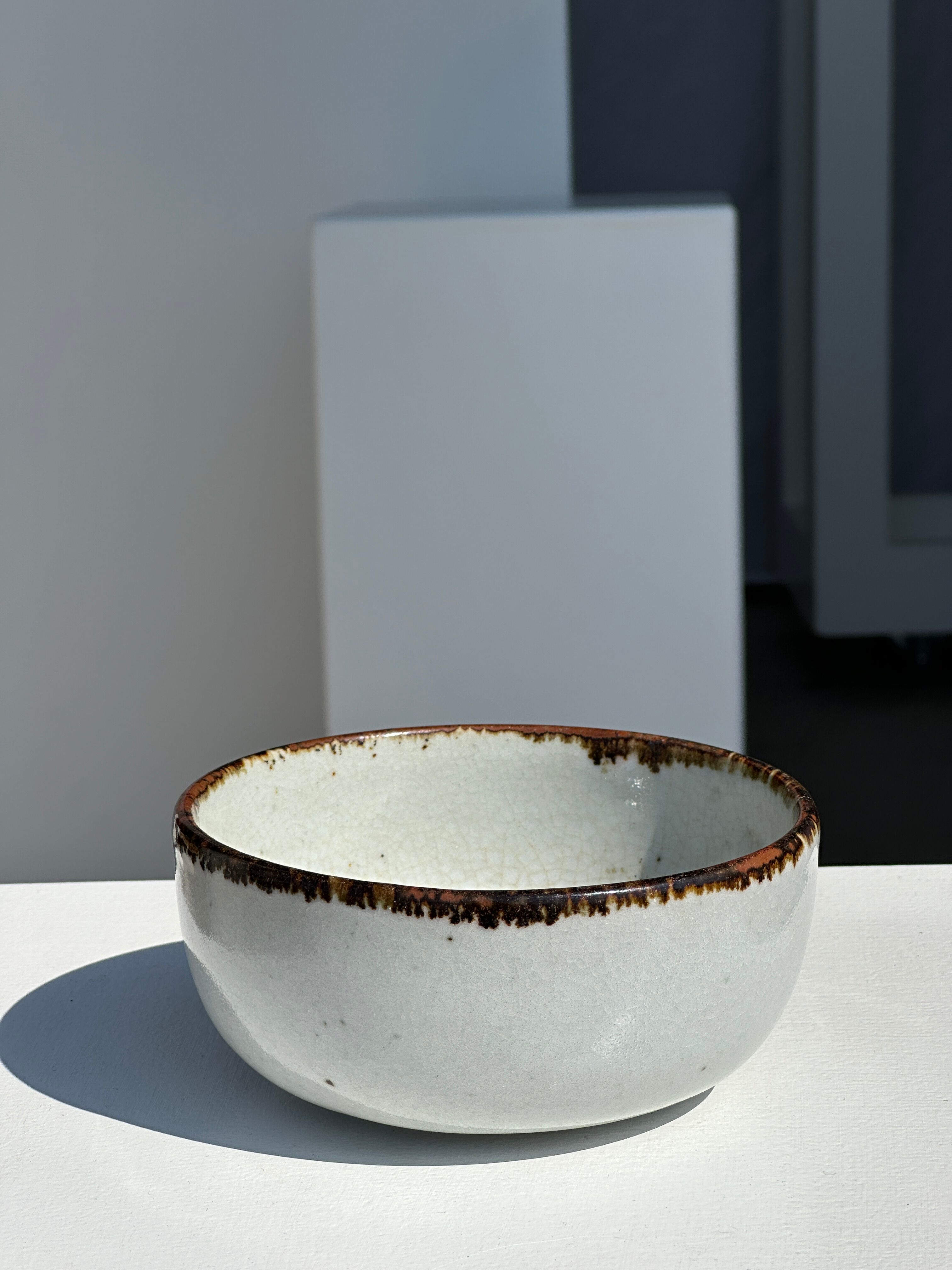 Small white glazed ceramic bowl black edges