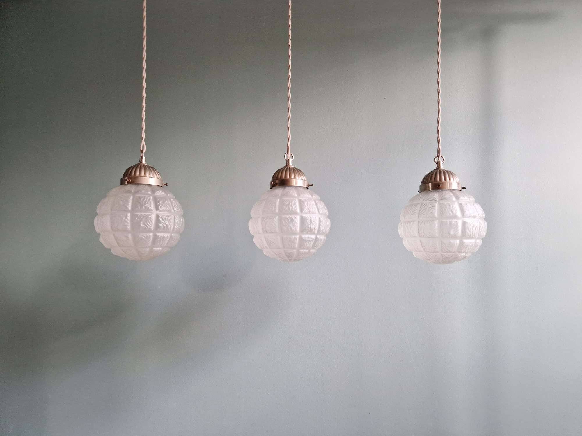 Art Deco trio of frosted glass pendants, 1920s-30s.
