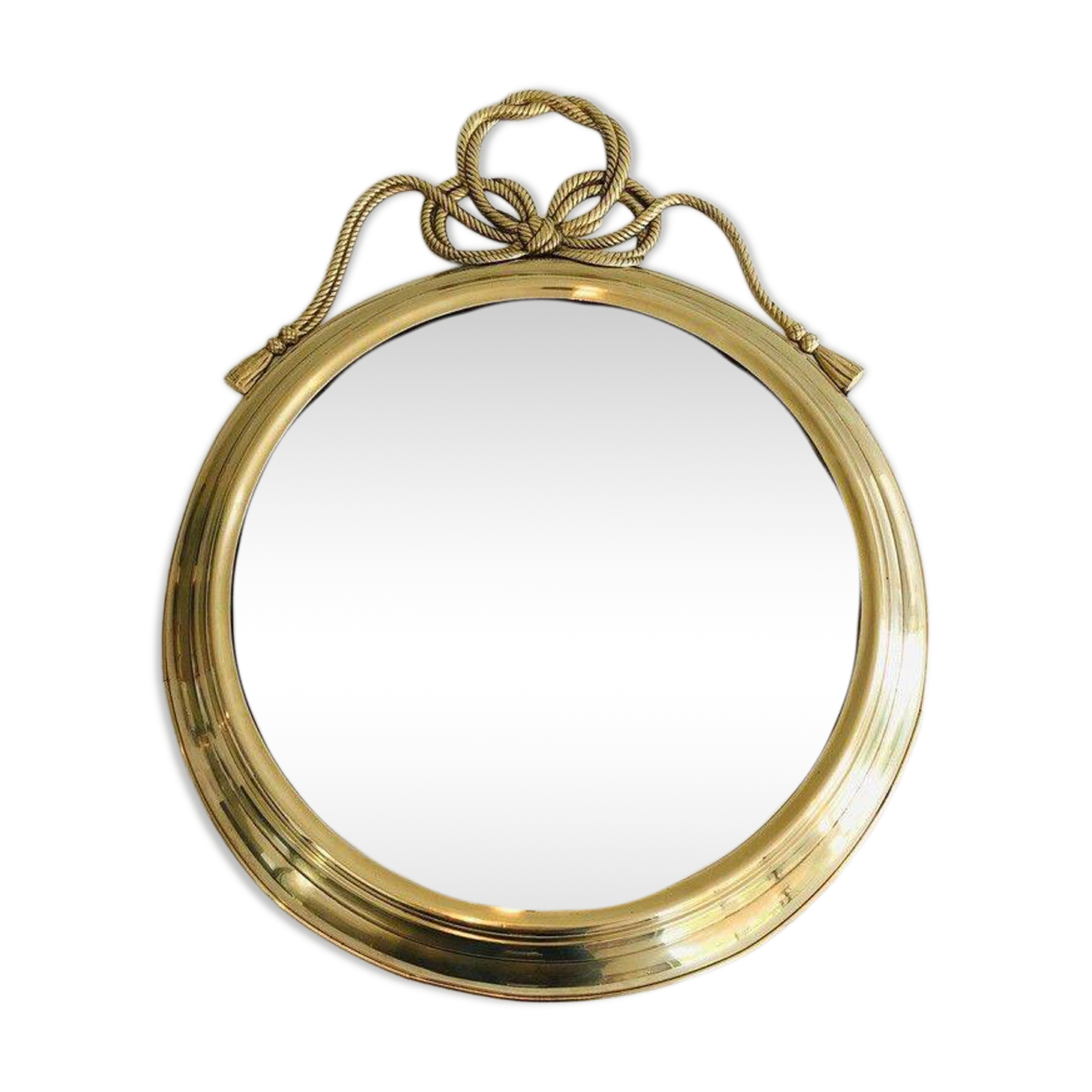 Large decorative oval mirror in brass adorned with a significant twisted bow.