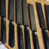 A set of 8 knives with black wooden handles
