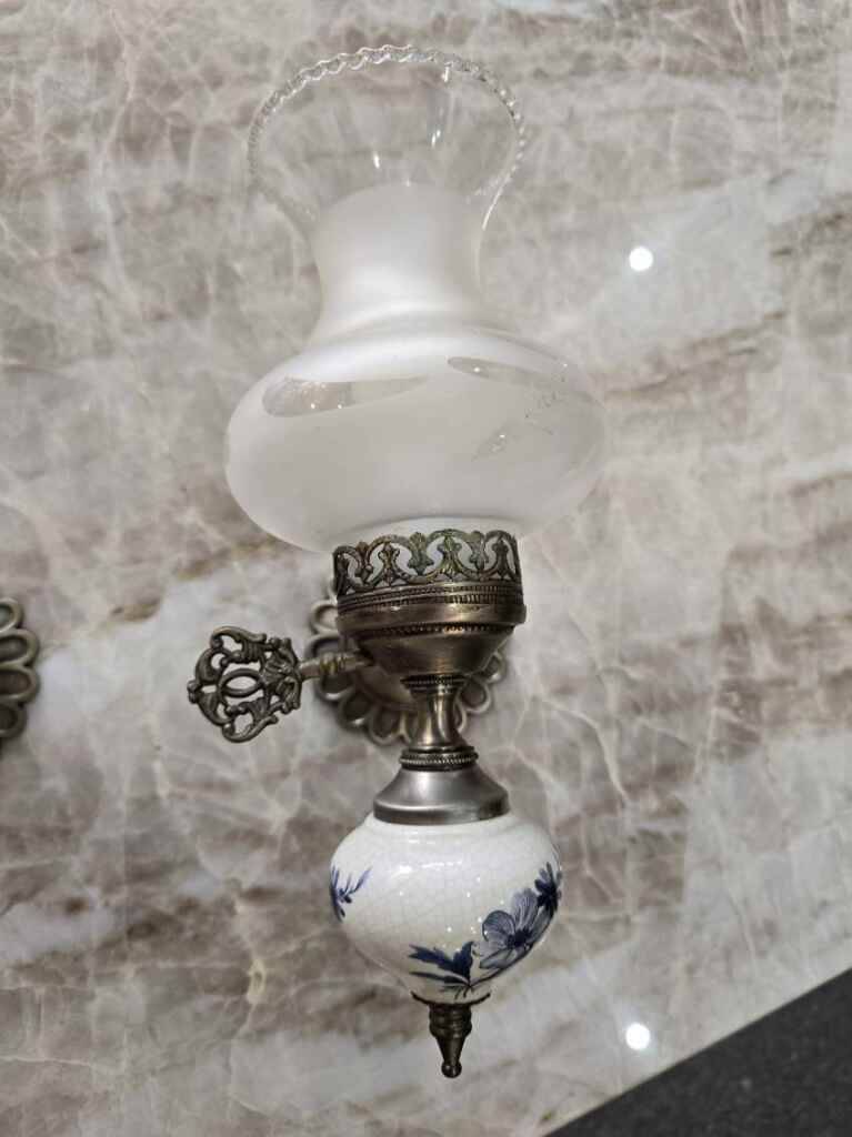 Pair of vintage wall sconces in brass, porcelain, and frosted glass.