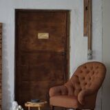 Victorian mahogany armchair, with wheels and coloured fabric, England, early 1900s.