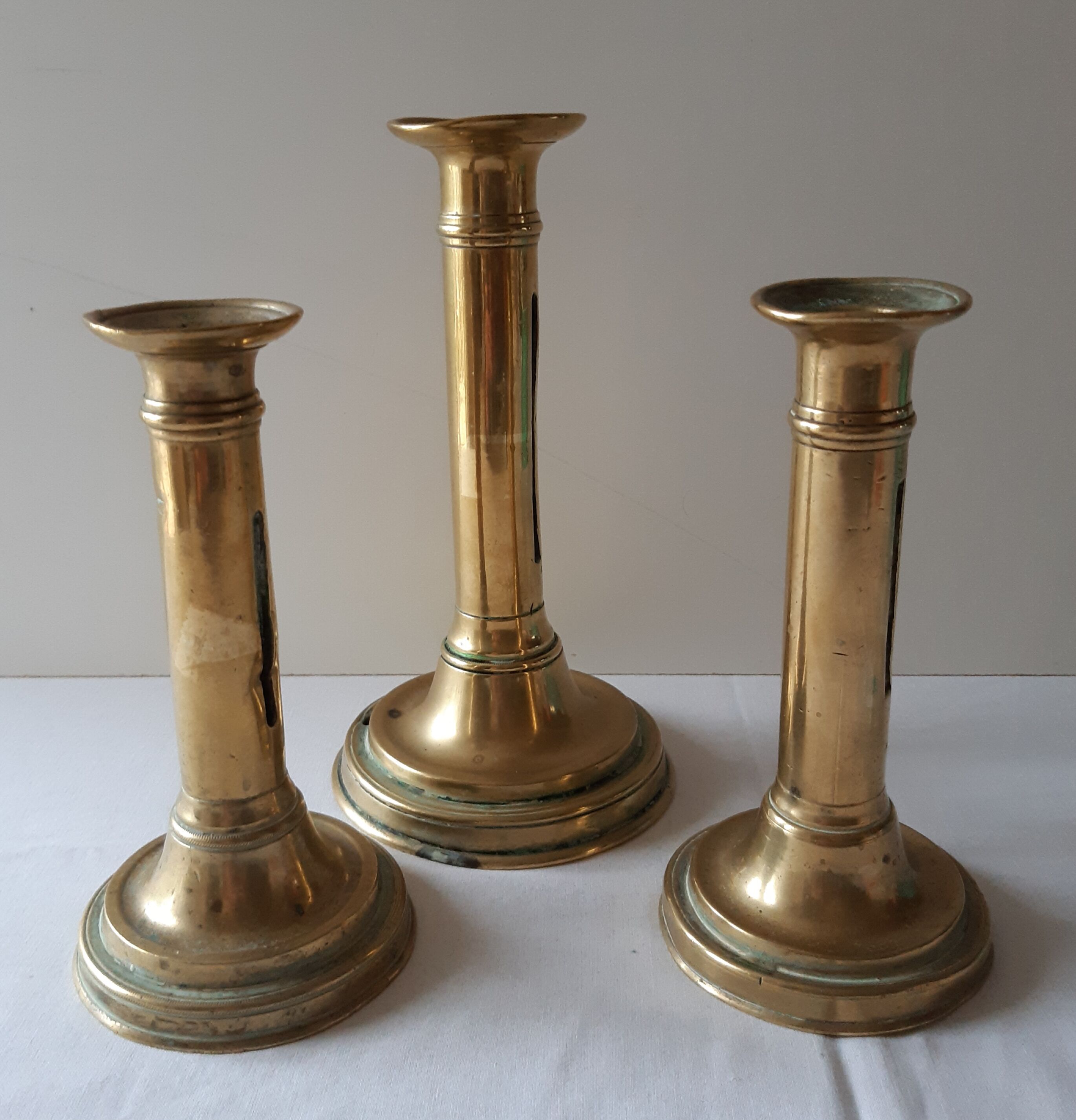 Lot of three old brass candlesticks