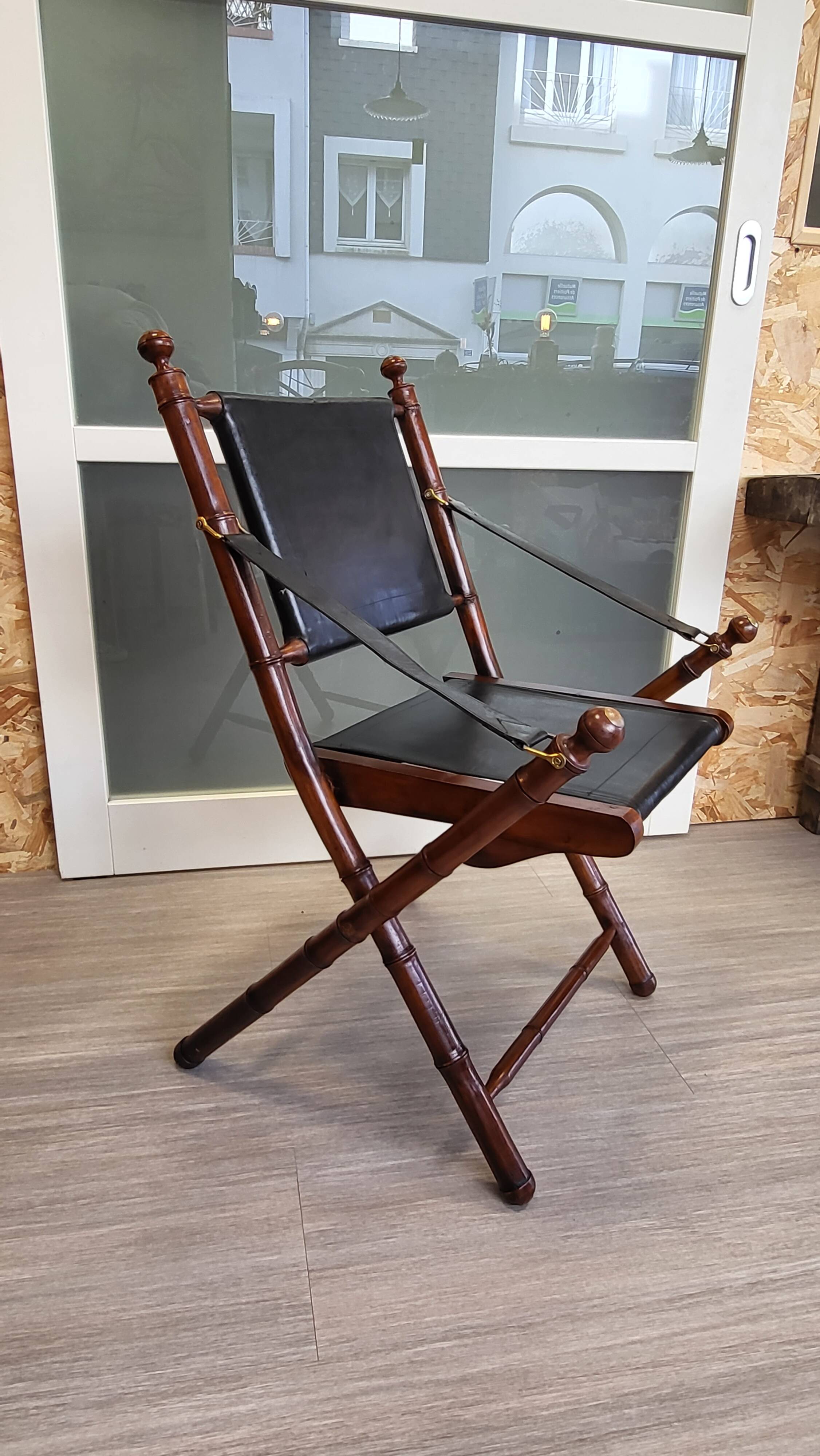 Colonial style folding leather and teak armchair