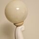 White ceramic table lamp, an elephant holding a lighted ball