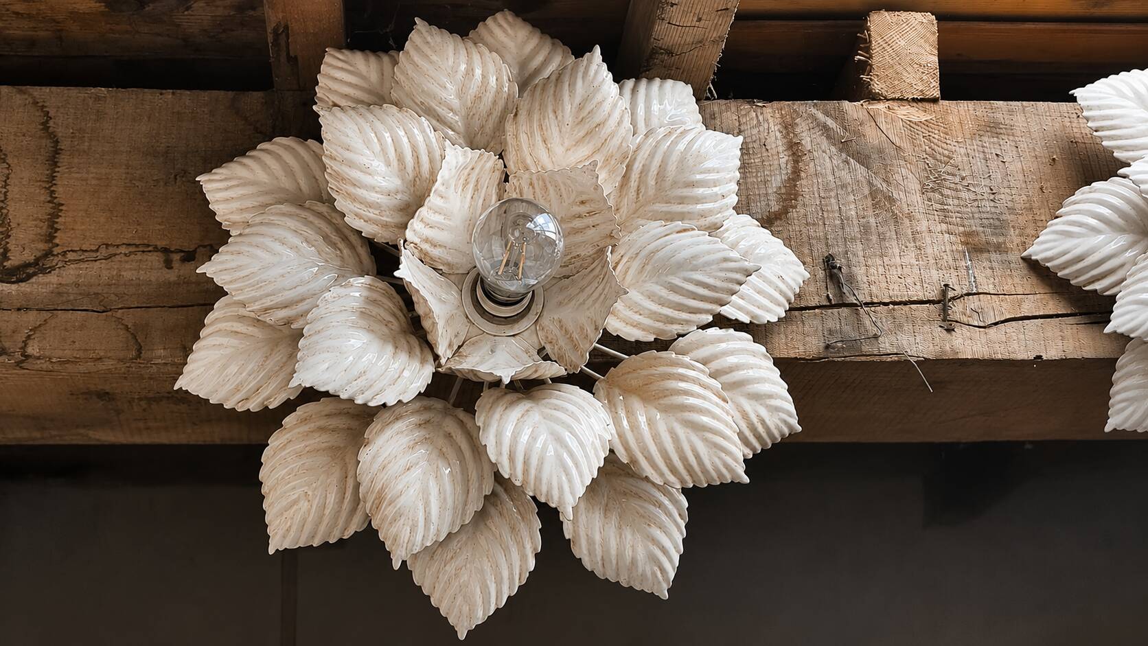 Flower applique attributed to Masca, 52cm in diameter.
