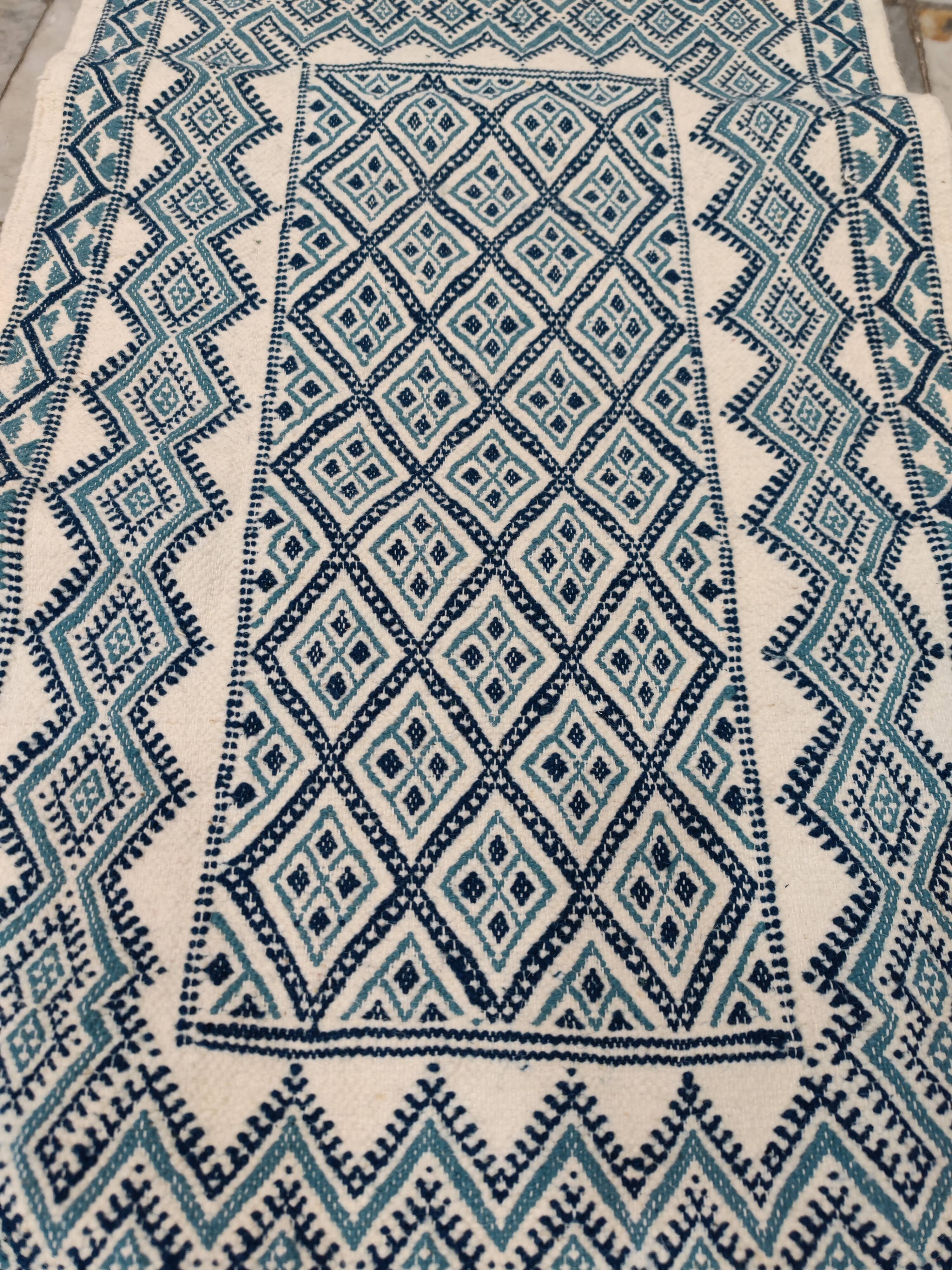 White and blue hand-woven rug in natural wool