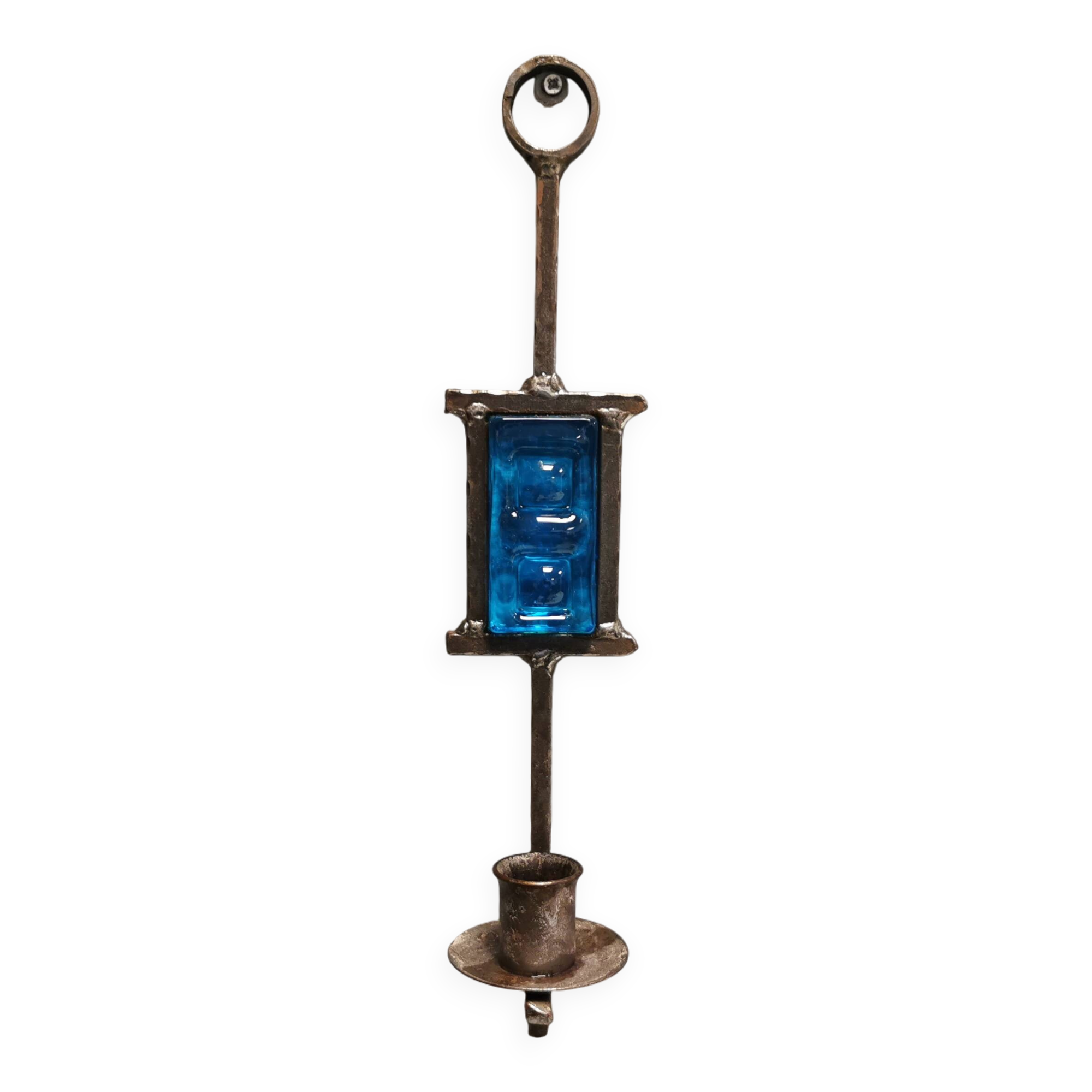 Wall-mounted candle holder in cast iron and hard pressed blue glass.