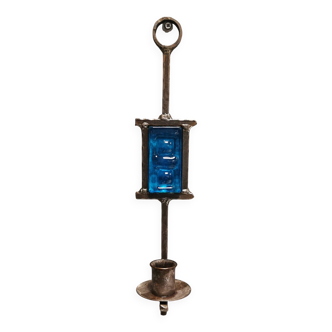 Wall-mounted candle holder in cast iron and hard pressed blue glass.