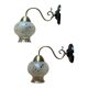 Pair of antique wall sconces in brass with tulip-shaped glass shades.